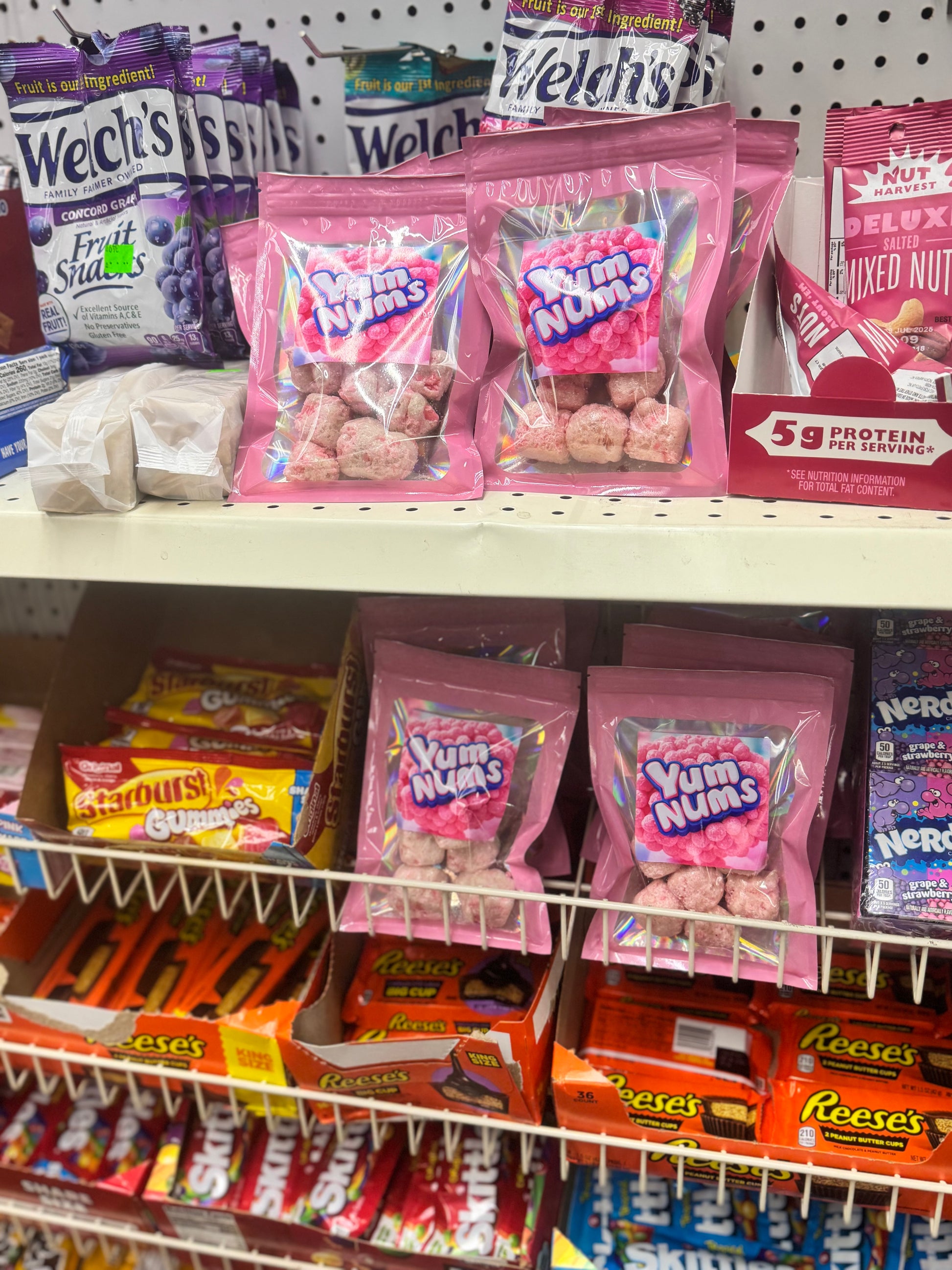 "Watermelon YumNums Freeze-Dried Candy bags displayed on a PetSmart store shelf, showcasing vibrant packaging of the crunchy, juicy watermelon snack."