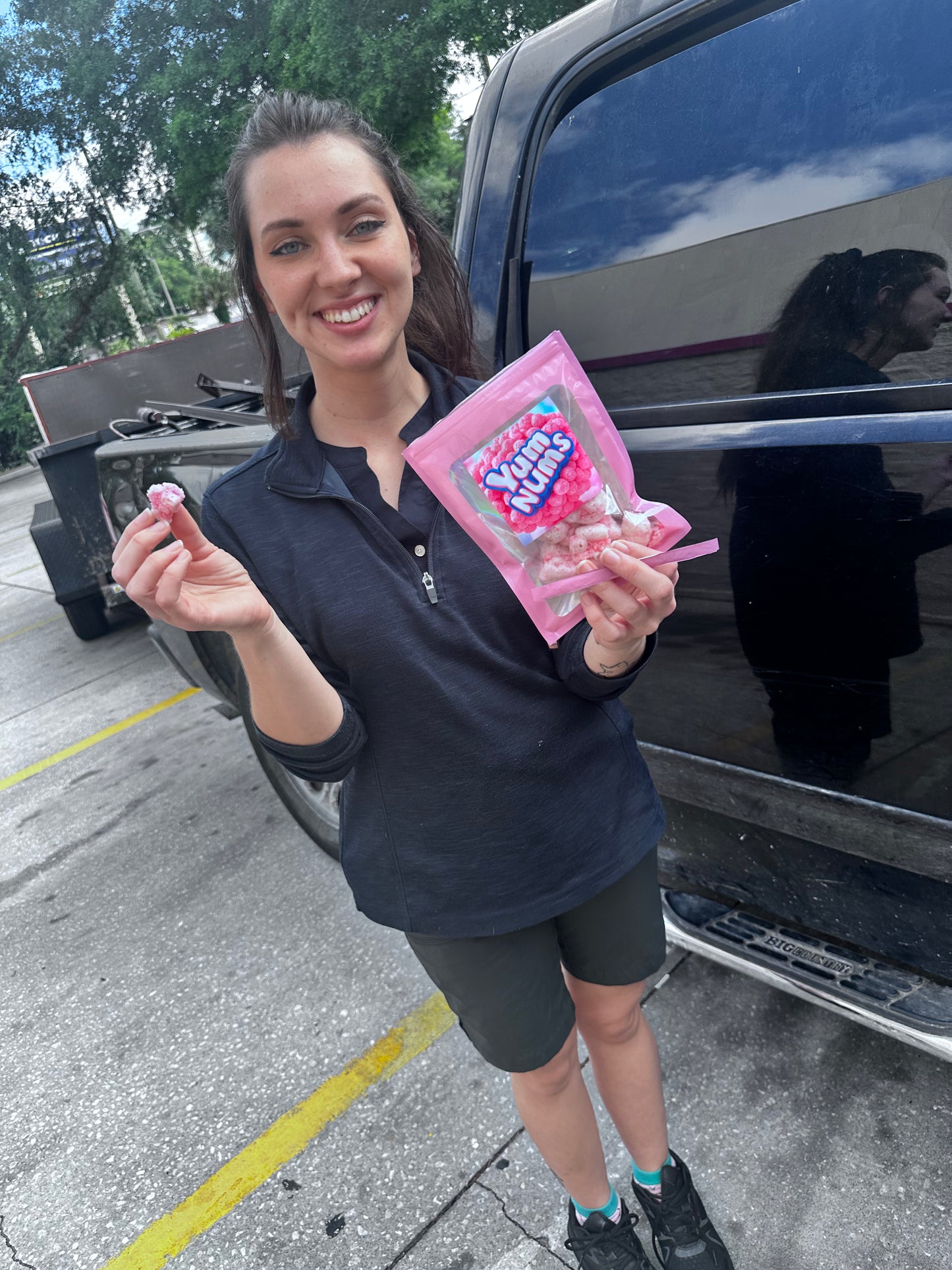 Chick fil a worker holding yumnums candy